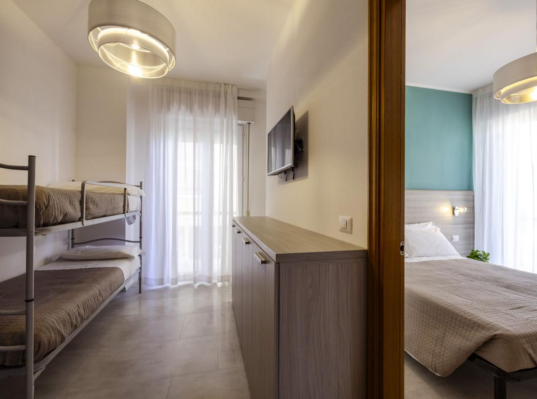 Modern room with bunk beds and warm light, cozy and serene.