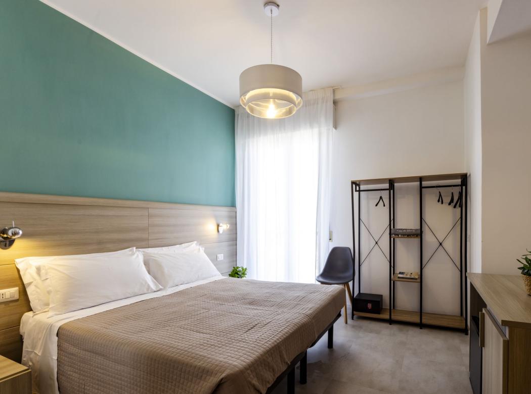 Modern, bright room with a cozy bed and minimalist decor.